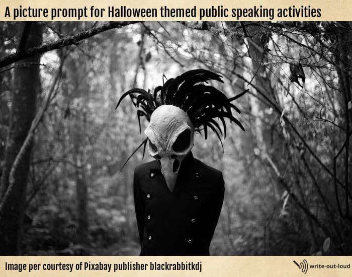 Black and white photo of a person in a forest clearing wearing a full-face bird skull mask